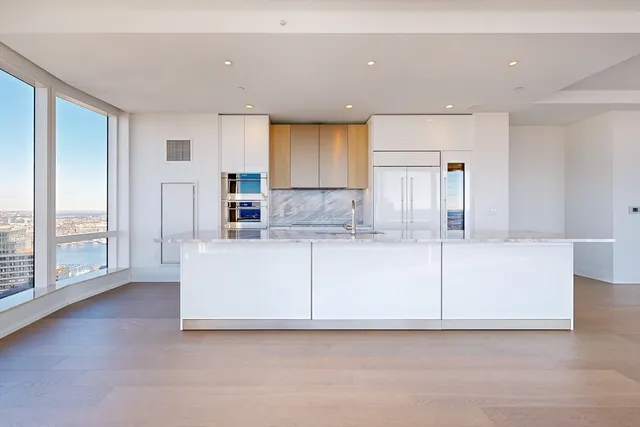 a view of kitchen with granite countertop cabinets and a sink