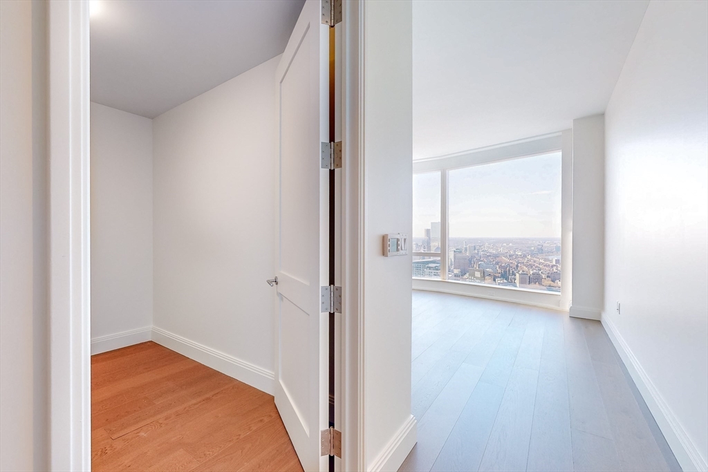 240 Devonshire Street, Unit U5401 Boston, MA 02110 - Photo 7 of 41 a view of a hallway with wooden floor and a bathroom