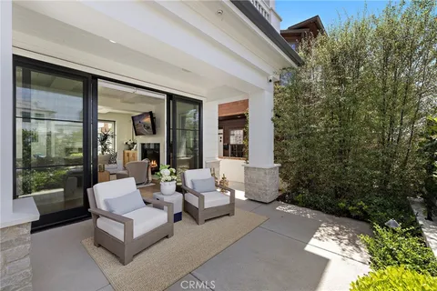 a view of a patio with couches table and chairs and potted plants