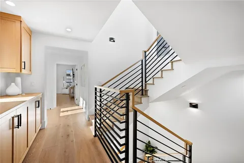 a view of entryway and hall with wooden floor