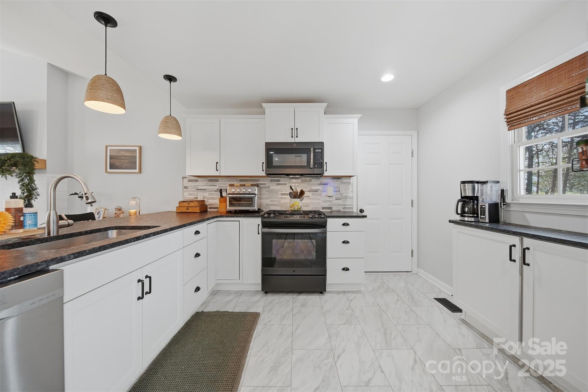 4687 Ransom Drive Conover, NC 28613 - Photo 12 of 27 a kitchen with granite countertop white cabinets and stainless steel appliances