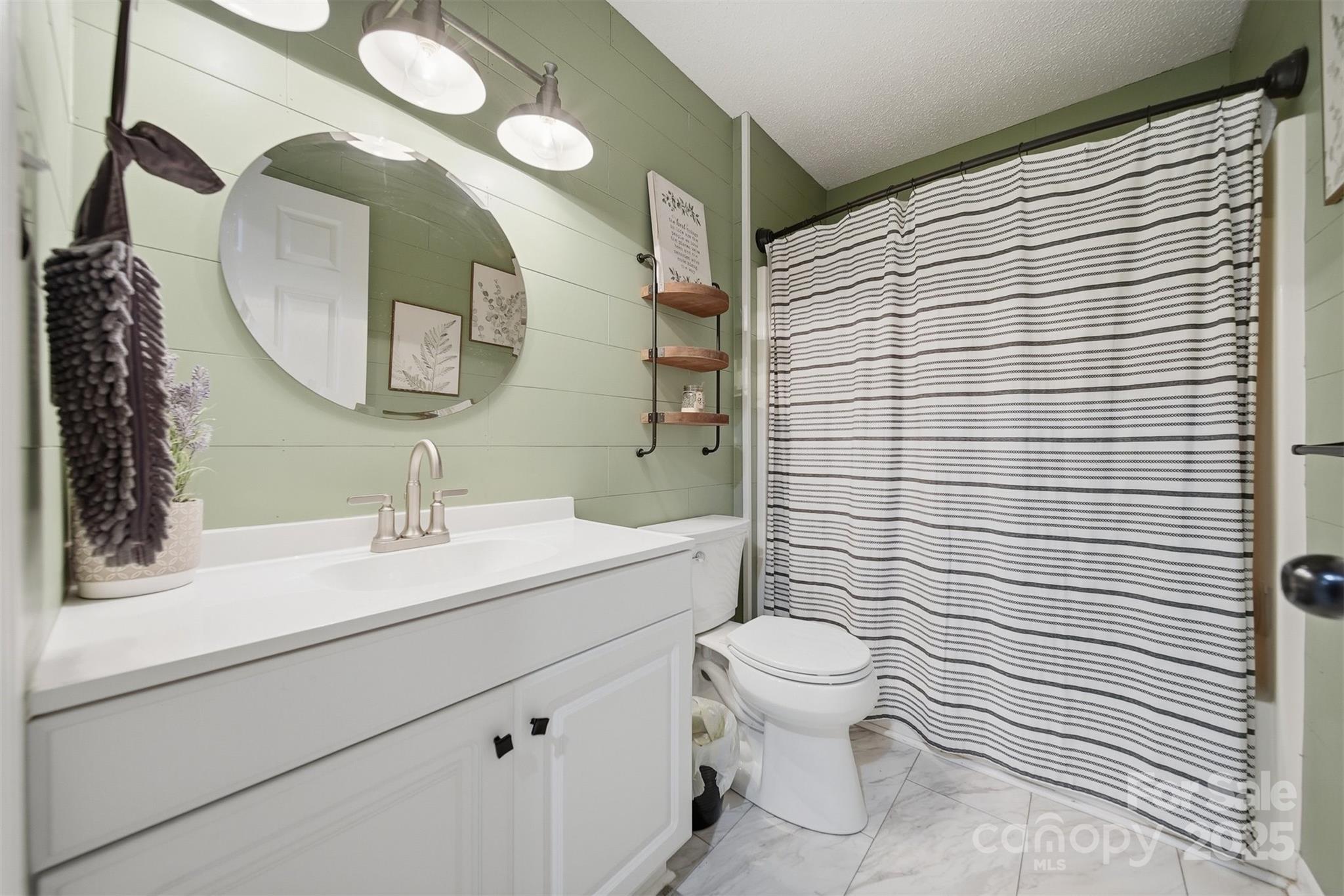 4687 Ransom Drive Conover, NC 28613 - Photo 9 of 27 a bathroom with a sink a toilet and mirror