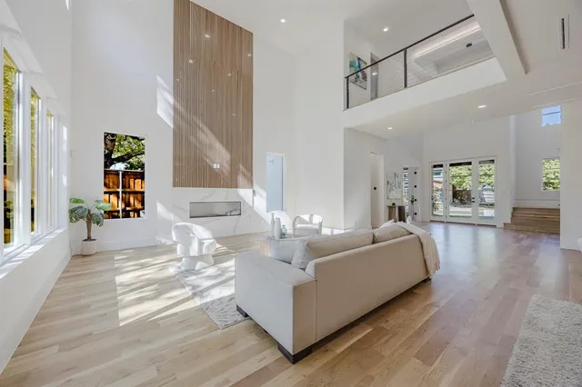 a dining room with furniture a chandelier and wooden floor