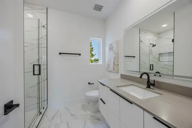 a view of walk in closet with wooden floor