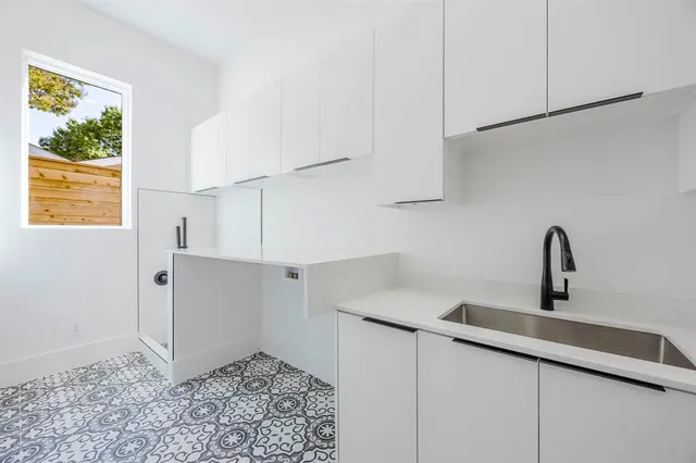 an empty room with white walls and windows