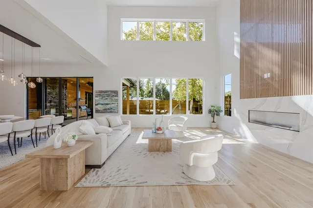 a living room with furniture and large windows