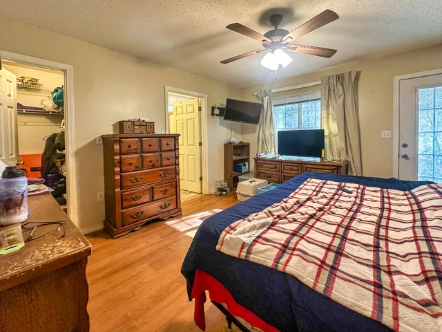 a bedroom with a bed and flat screen tv