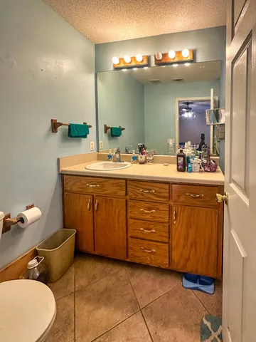 a spacious bathroom with a double vanity sink and a mirror