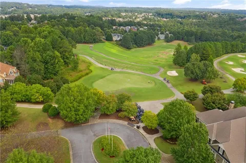 an aerial view of a house with yard