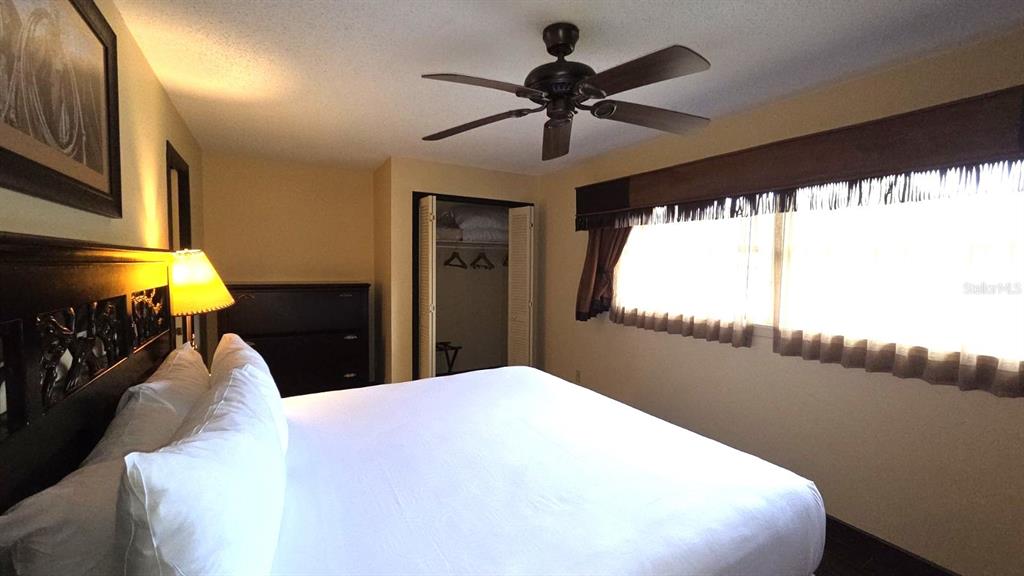 454 Cottage Circle, Unit 454 River Ranch, FL 33867 - Photo 15 of 27 a bed room with a bed and a chandelier
