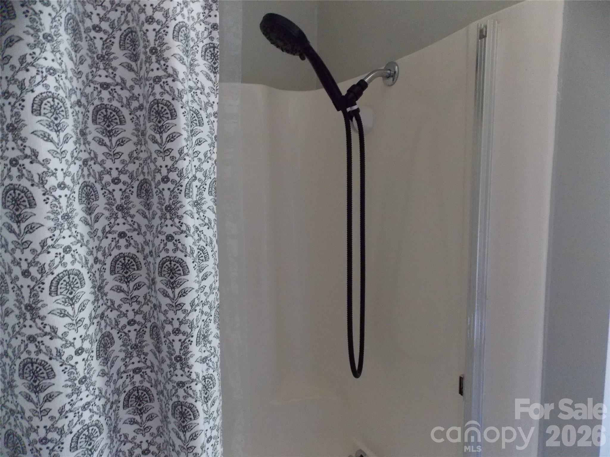 1380 May Road Granite Falls, NC 28630 - Photo 12 of 26 a bathroom with a shower curtain and a shower