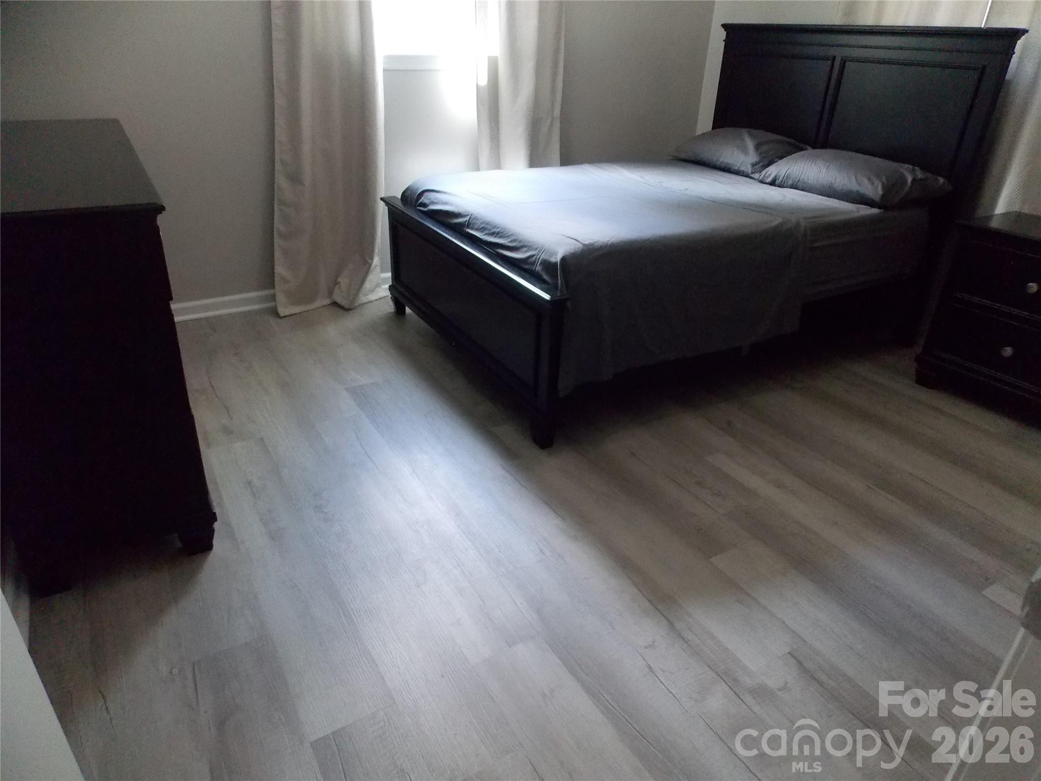 1380 May Road Granite Falls, NC 28630 - Photo 14 of 26 a bedroom with a bed and wooden floor
