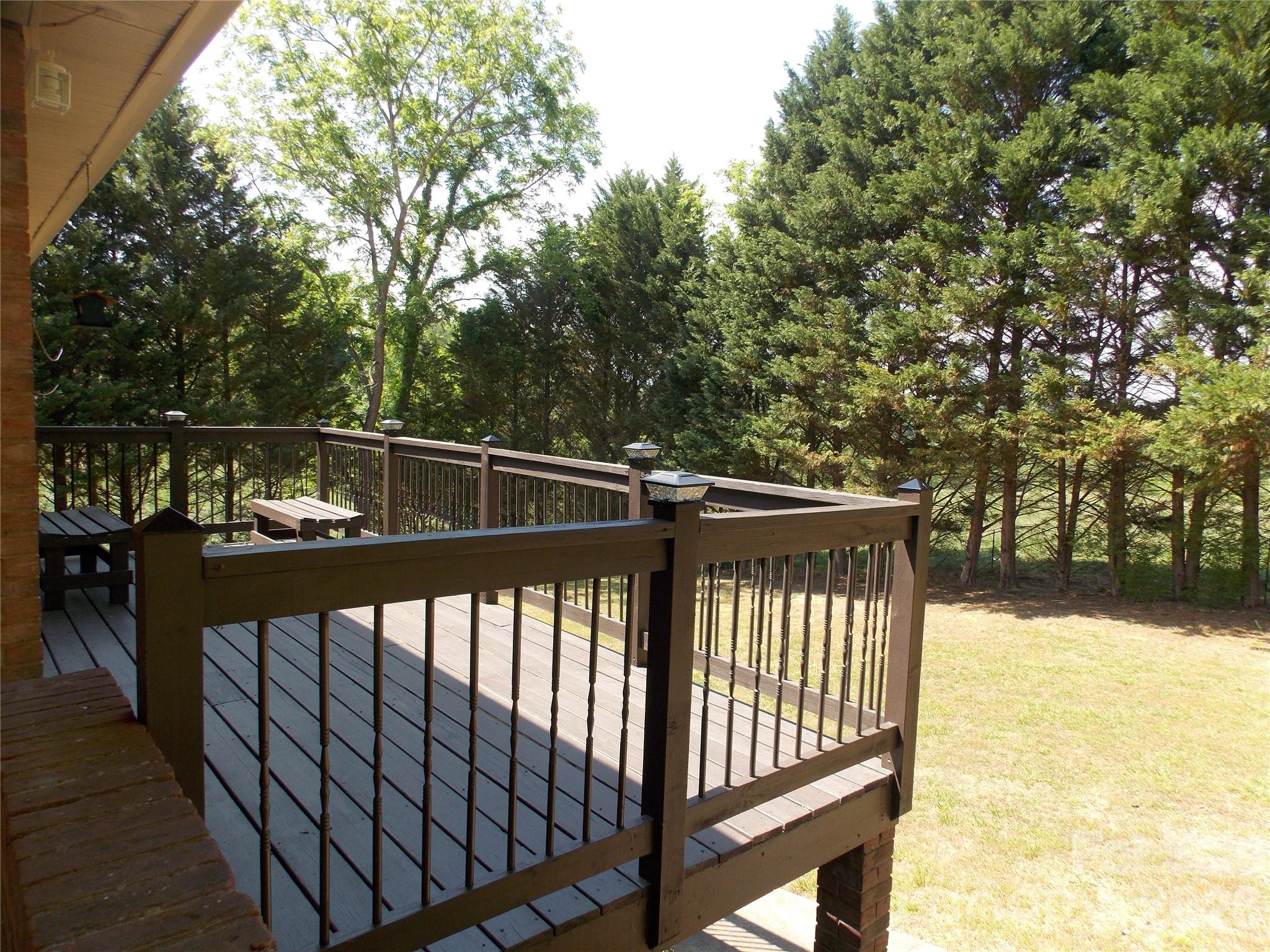1380 May Road Granite Falls, NC 28630 - Photo 17 of 26 a view of deck with large trees and wooden fence