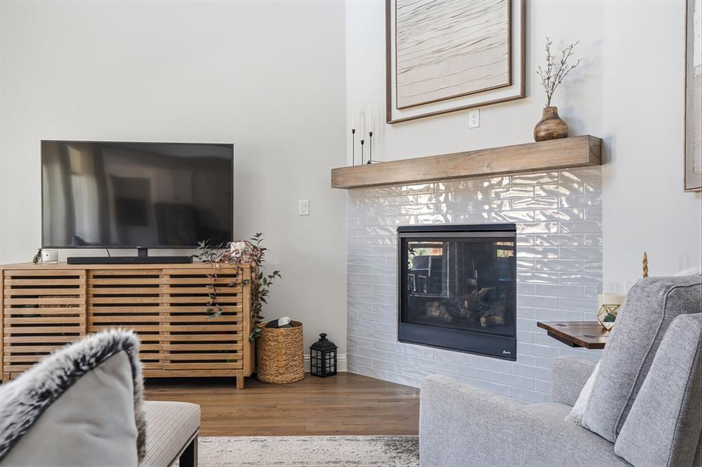 4202 Crown Run Road Midlothian, TX 76065 - Photo 6 of 34 Corner fireplace with light-colored, textured tile surround and a substantial wood mantel