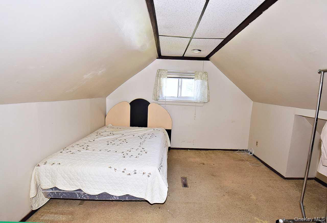 14 East Walnut Street Central Islip, NY 11722 - Photo 12 of 18 a bedroom with a bed and a window