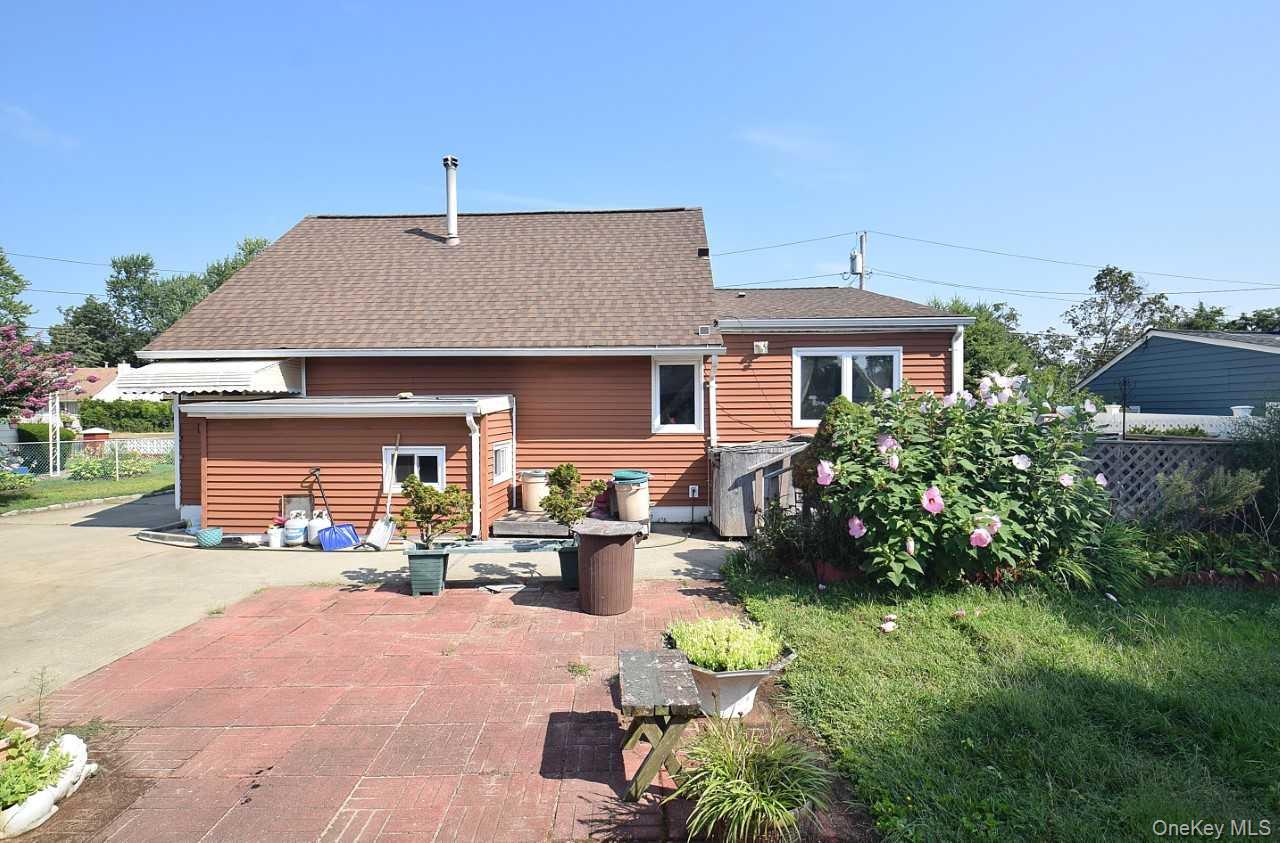 14 East Walnut Street Central Islip, NY 11722 - Photo 14 of 18 a front view of a house with a yard