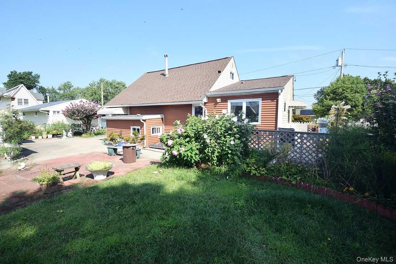 14 East Walnut Street Central Islip, NY 11722 - Photo 15 of 18 a view of a house with backyard porch and garden