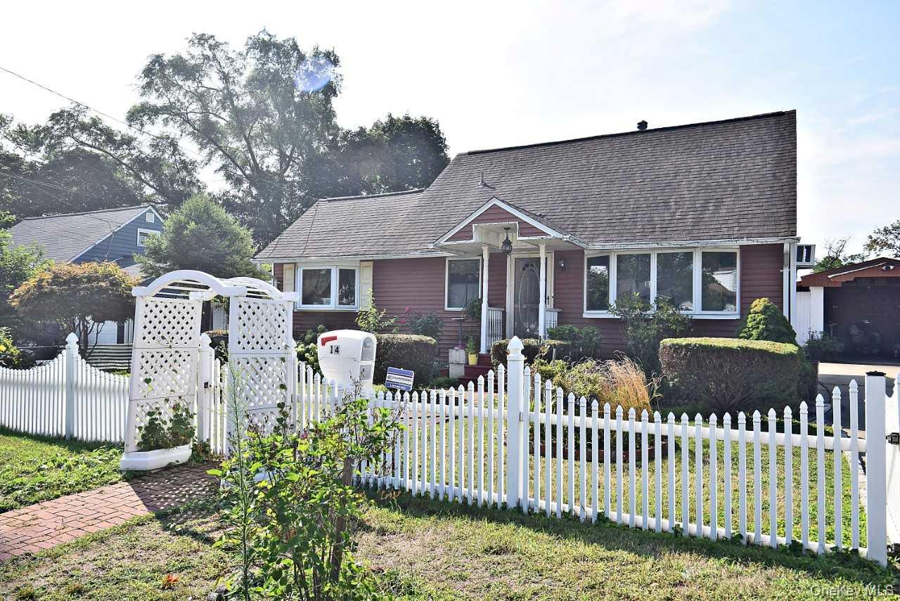 14 East Walnut Street Central Islip, NY 11722 - Photo 2 of 18 a front view of a house with a garden