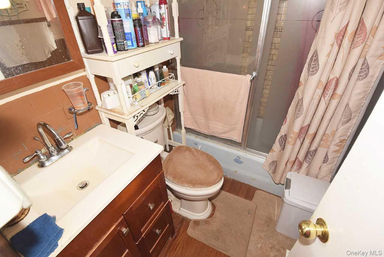 14 East Walnut Street Central Islip, NY 11722 - Photo 6 of 18 a bathroom with a sink a toilet and a mirror