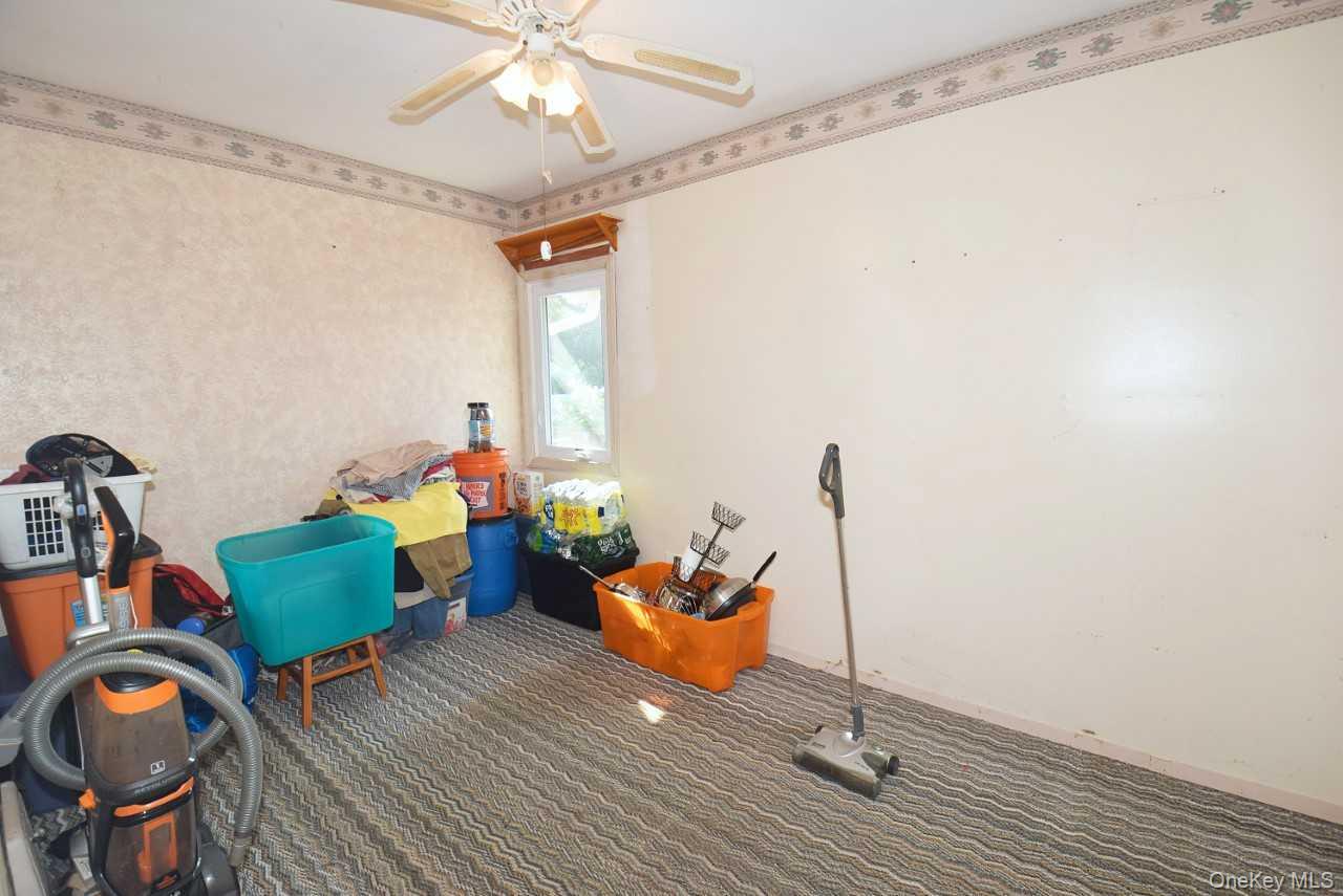 14 East Walnut Street Central Islip, NY 11722 - Photo 10 of 18 a living room with furniture and a chandelier