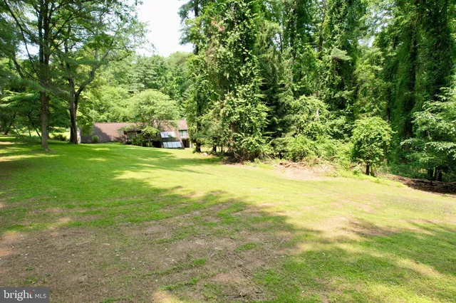 a backyard of a house with lots of green space and garden
