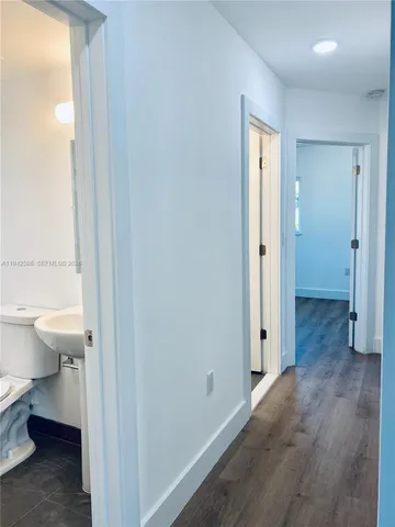 a view of a bathroom with toilet a sink and a closet