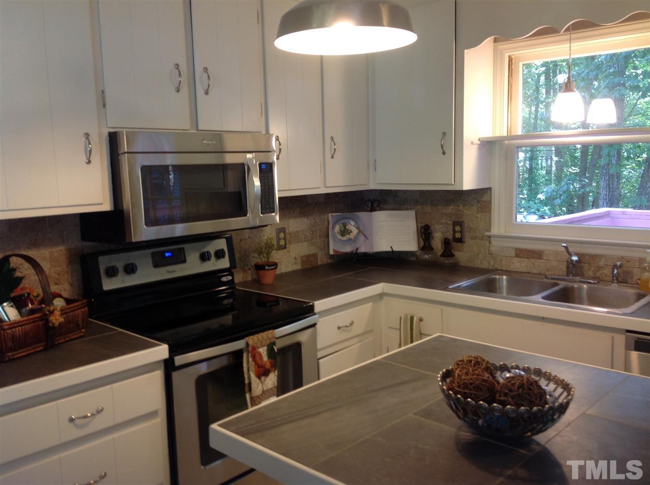 Nice open and sunny kitchen with new appliances and center island for entertaining