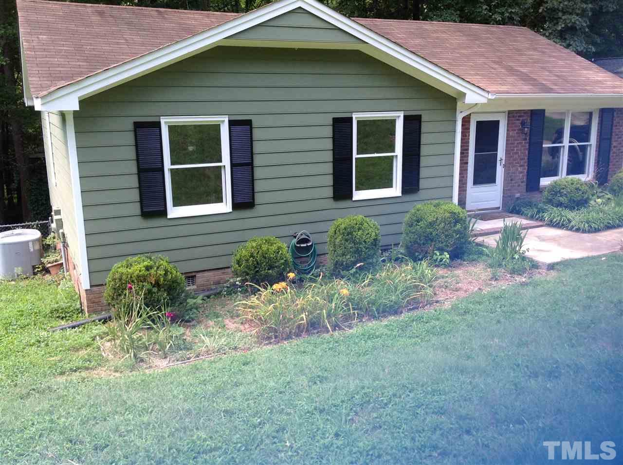 Inviting ranch cottage with nice bedding areas at the front of the home for gardening