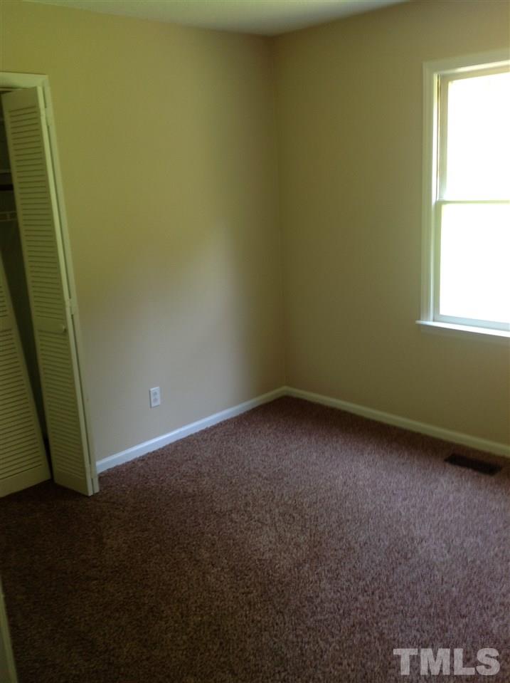 7113 Tyndall Court Raleigh, NC 27615 - Photo 8 of 13 Sunny first bedroom with nice sized closet area, new carpeting and lighting fixtures