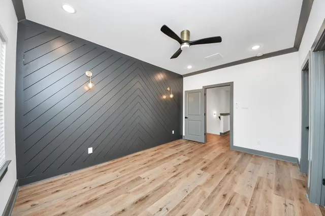a view of a livingroom with a hall and wooden floor