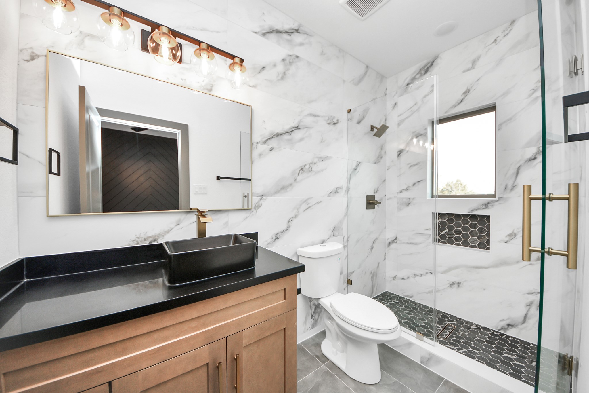 7925 Ritz Street, Unit A Houston, TX 77028 - Photo 24 of 35 a bathroom with a granite countertop toilet sink and mirror