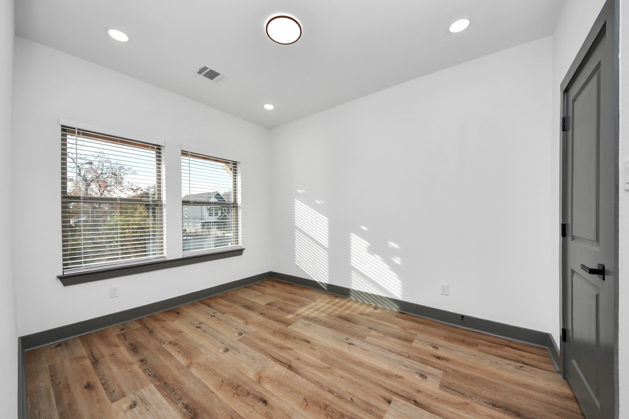 7925 Ritz Street, Unit A Houston, TX 77028 - Photo 28 of 35 a view of an empty room with wooden floor and a window