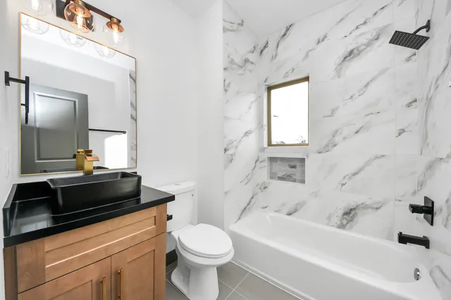 a bathroom with a sink a toilet and bathtub