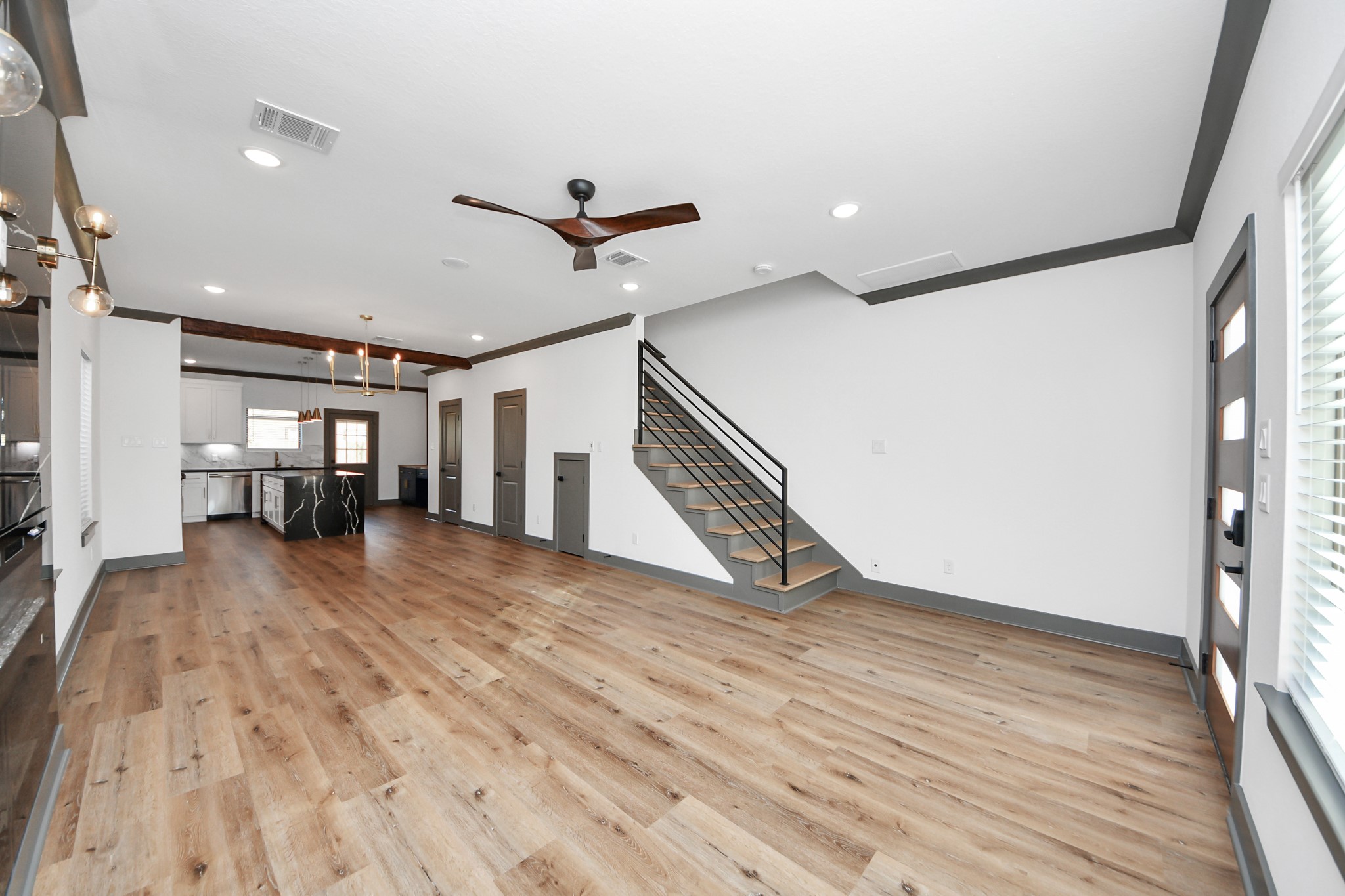 7925 Ritz Street, Unit A Houston, TX 77028 - Photo 5 of 35 a view of empty room with wooden floor and fan