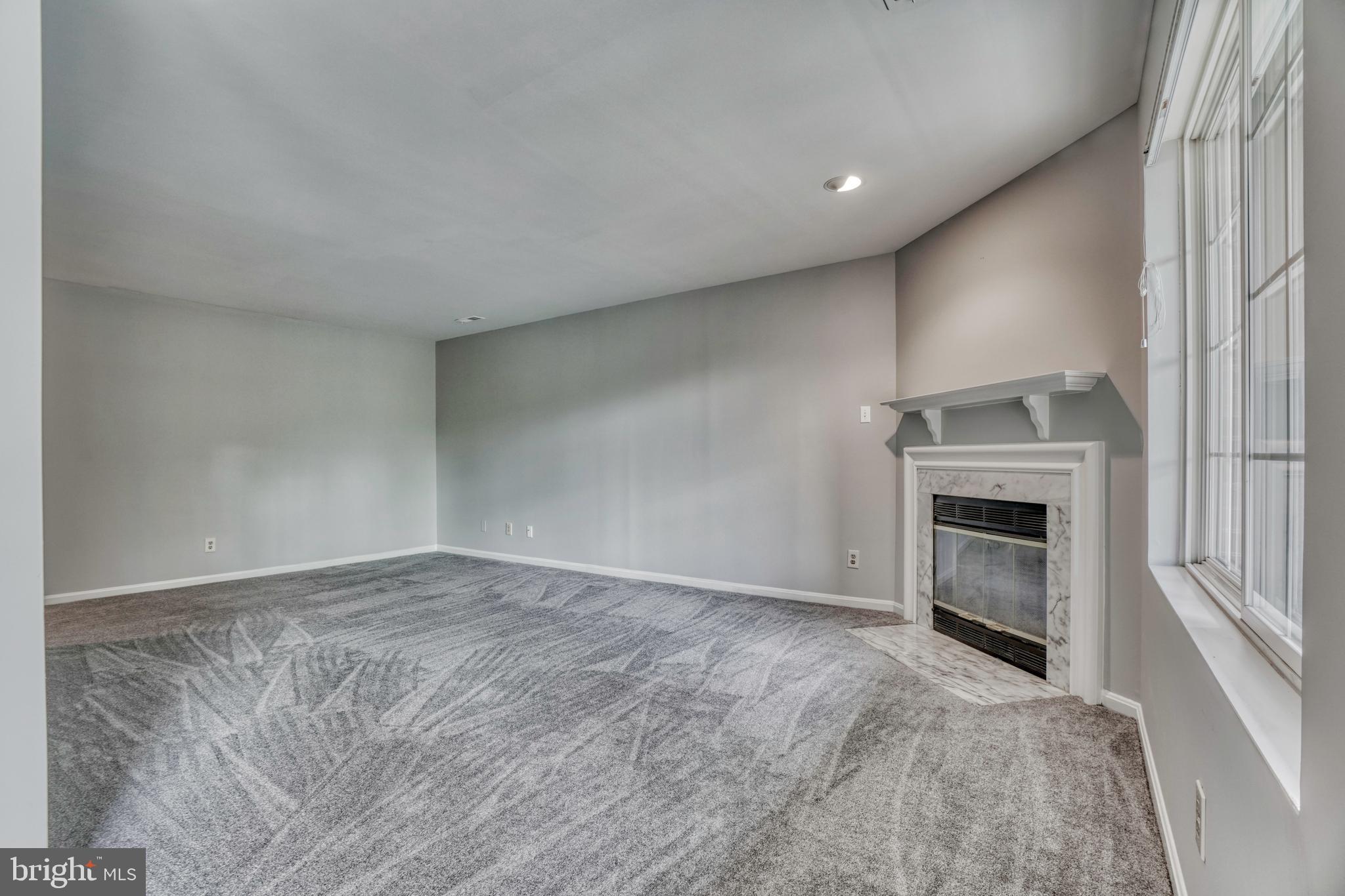 408 Kilree Road, Unit 202 Lutherville-Timonium, MD 21093 - Photo 14 of 33 Large living room accented by gas fireplace.