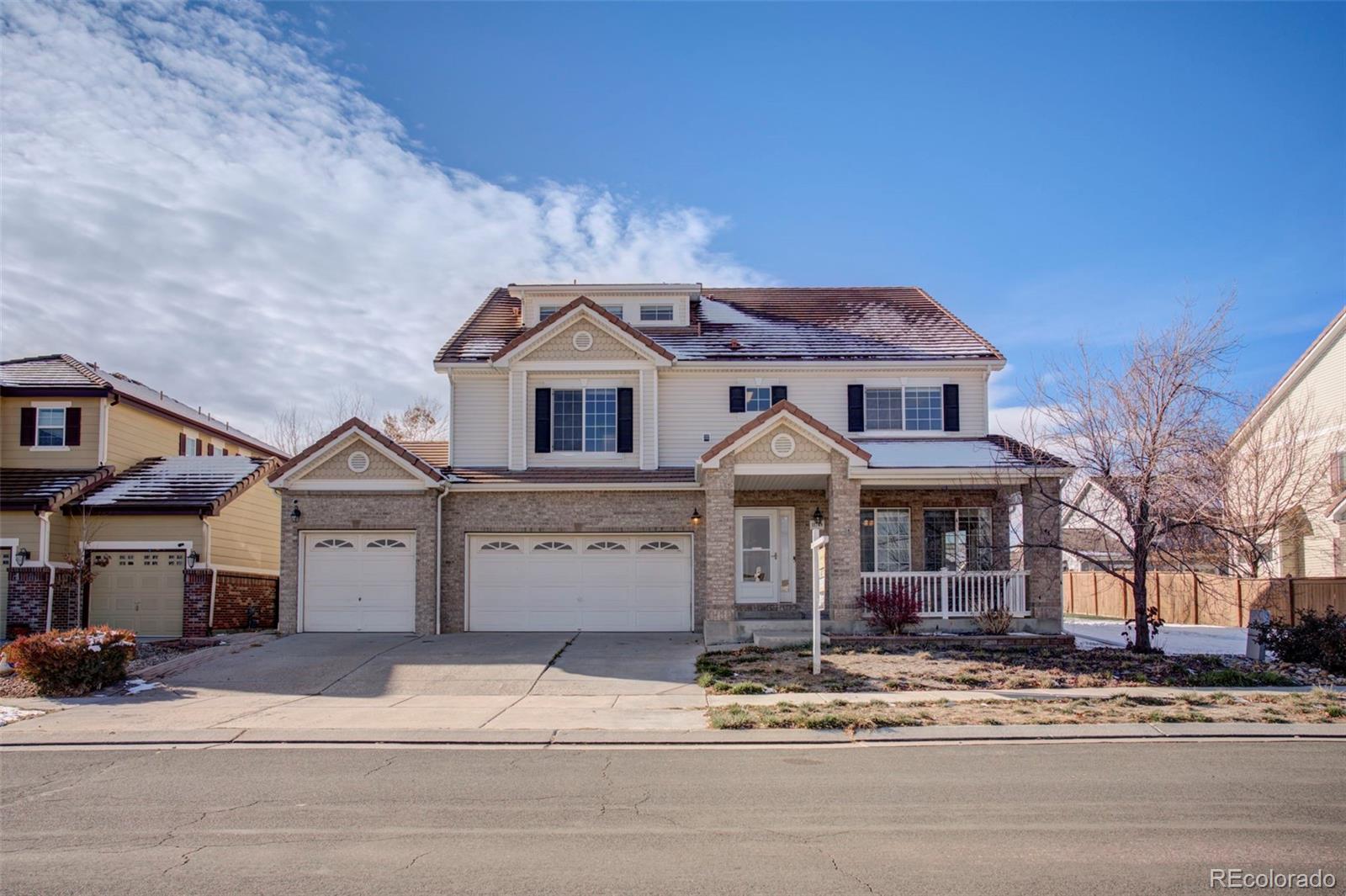 11749 Jasper Street Commerce City, CO 80022 - Photo 1 of 40 a front view of a house with a garden