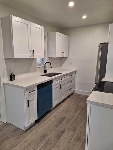 a kitchen with a sink stove and cabinets