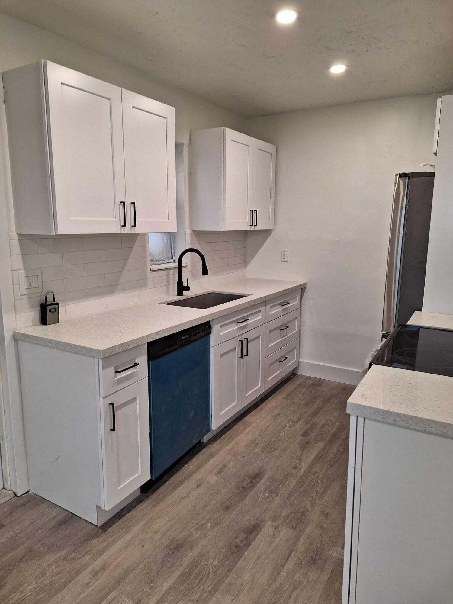 1000 West 1st Street Riviera Beach, FL 33404 - Photo 3 of 8 a kitchen with a sink stove and cabinets