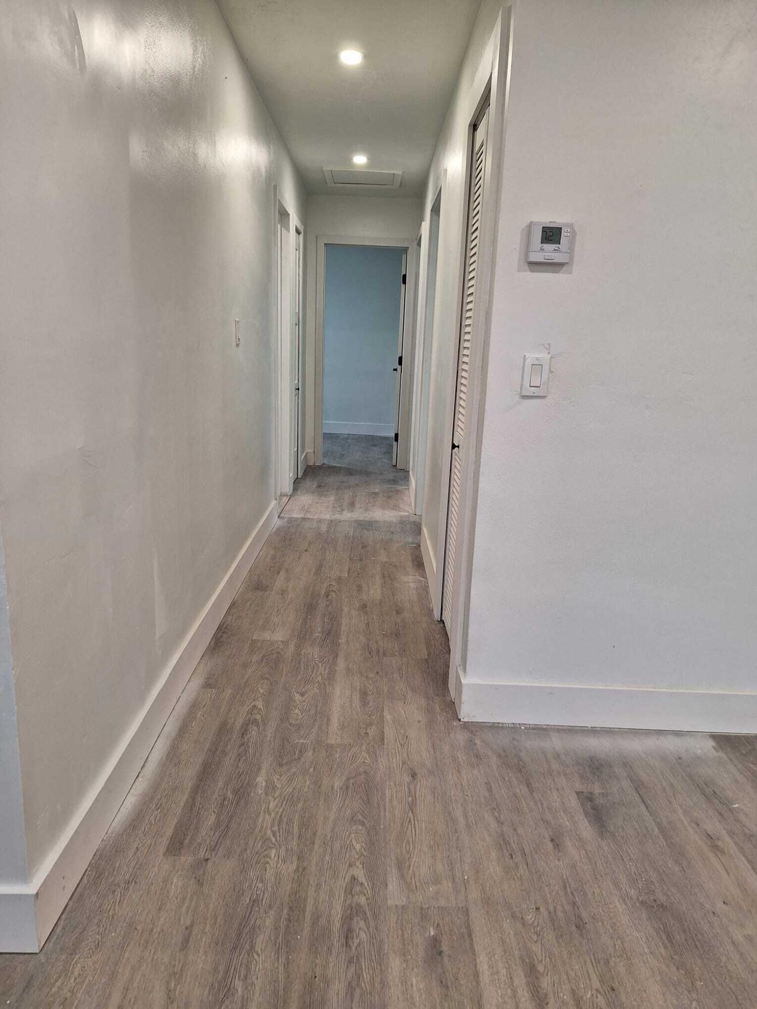 1000 West 1st Street Riviera Beach, FL 33404 - Photo 7 of 8 a view of a hallway with wooden floor