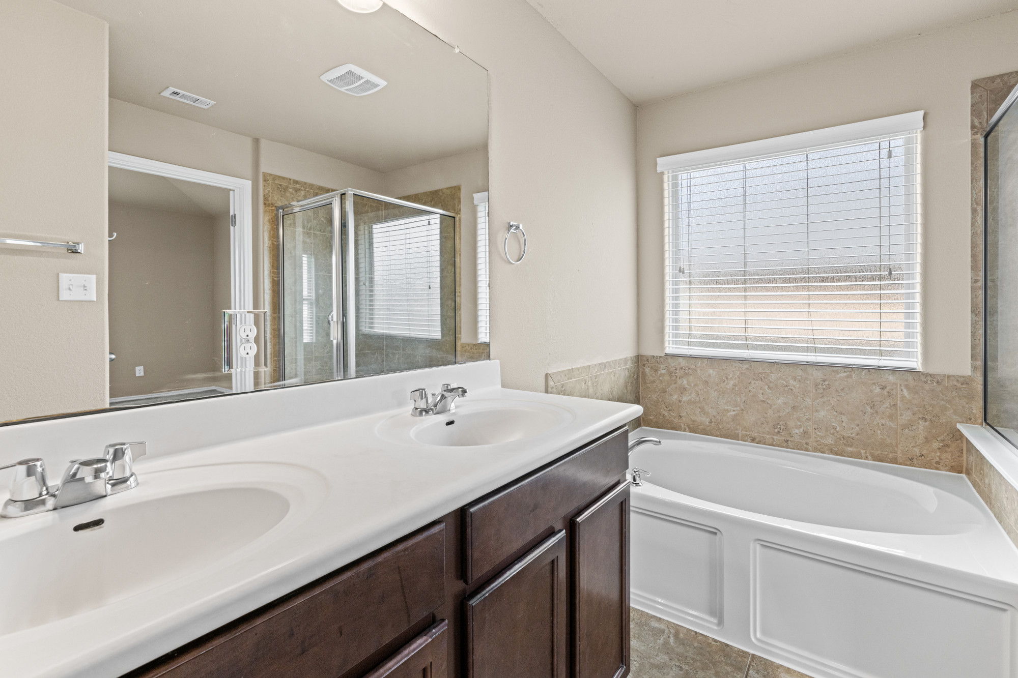 19308 Stokes Lane Pflugerville, TX 78660 - Photo 13 of 27 Dual vanity with undermount sinks, chrome fixtures, and dark wood-finish cabinetry