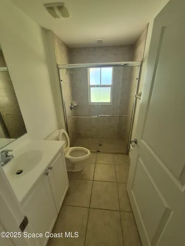 a bathroom with a sink a toilet and a shower