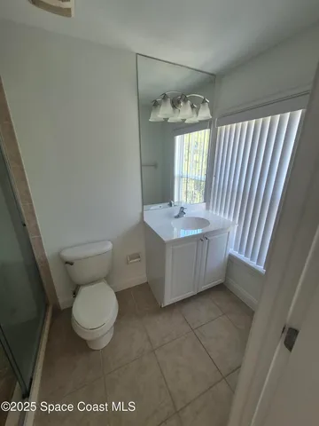 a bathroom with a toilet and shower