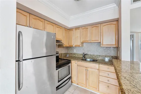 a white refrigerator freezer sitting inside of a kitchen