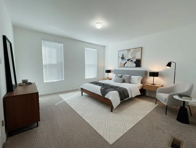 a spacious bedroom with a bed and a couch