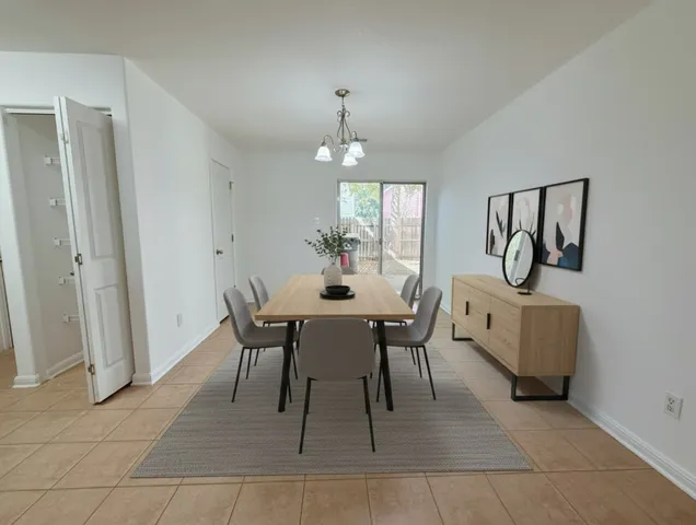 a dining room with furniture a rug and a chandelier