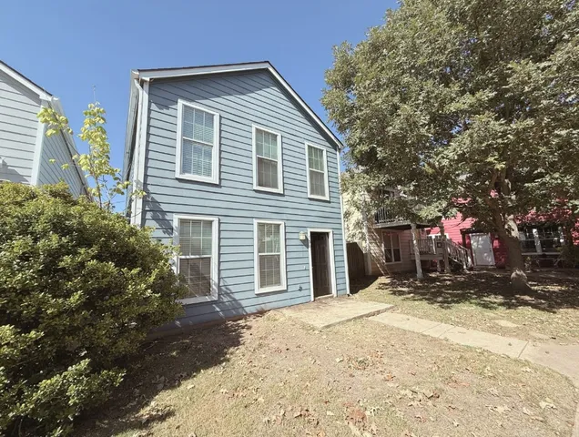 a front view of a house with a yard covered in snow