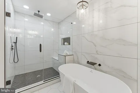a bathroom with a bathtub and shower