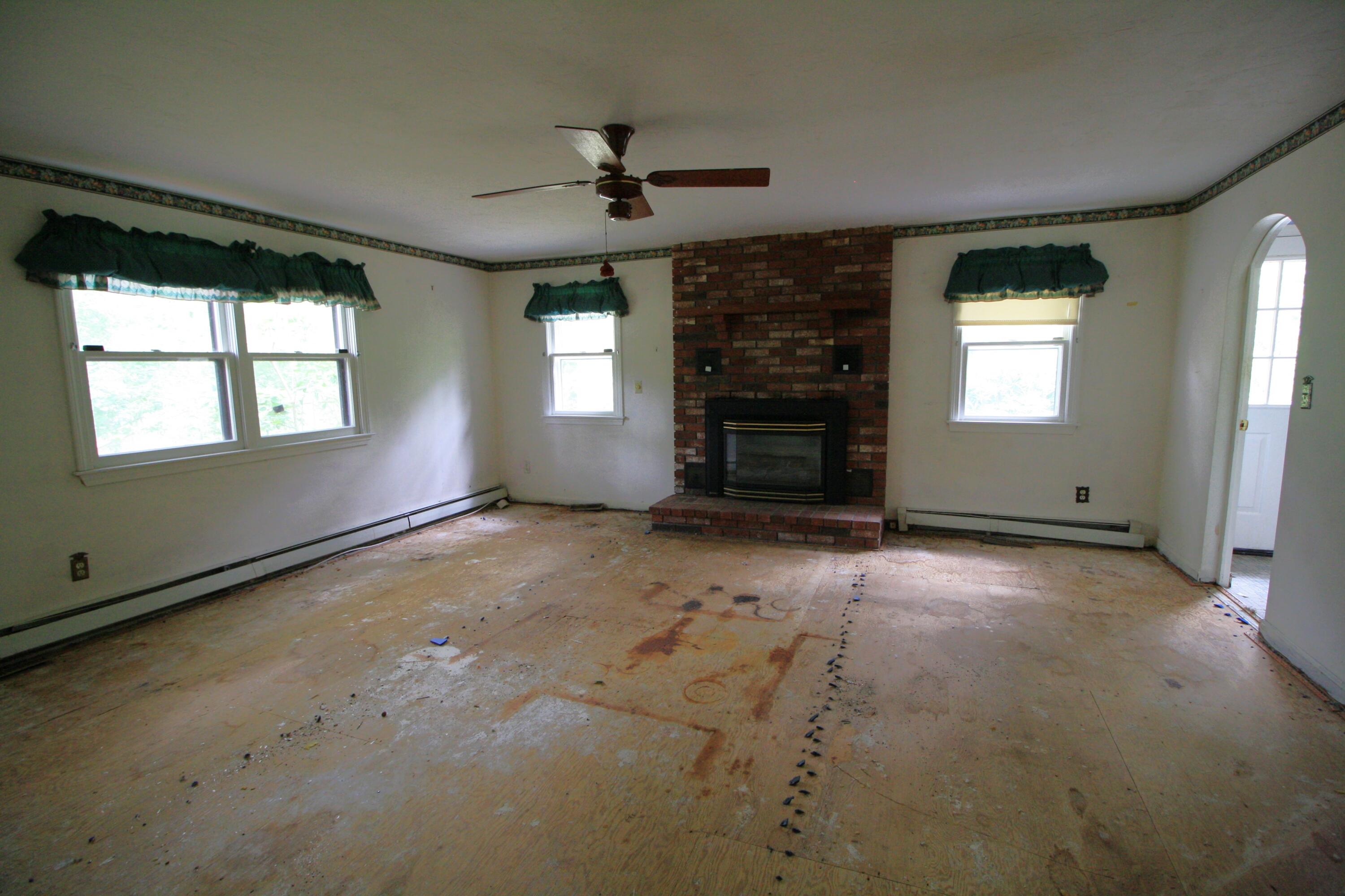 177 Thistle Drive Centerville, MA 02632 - Photo 13 of 22 an empty room with windows and fireplace