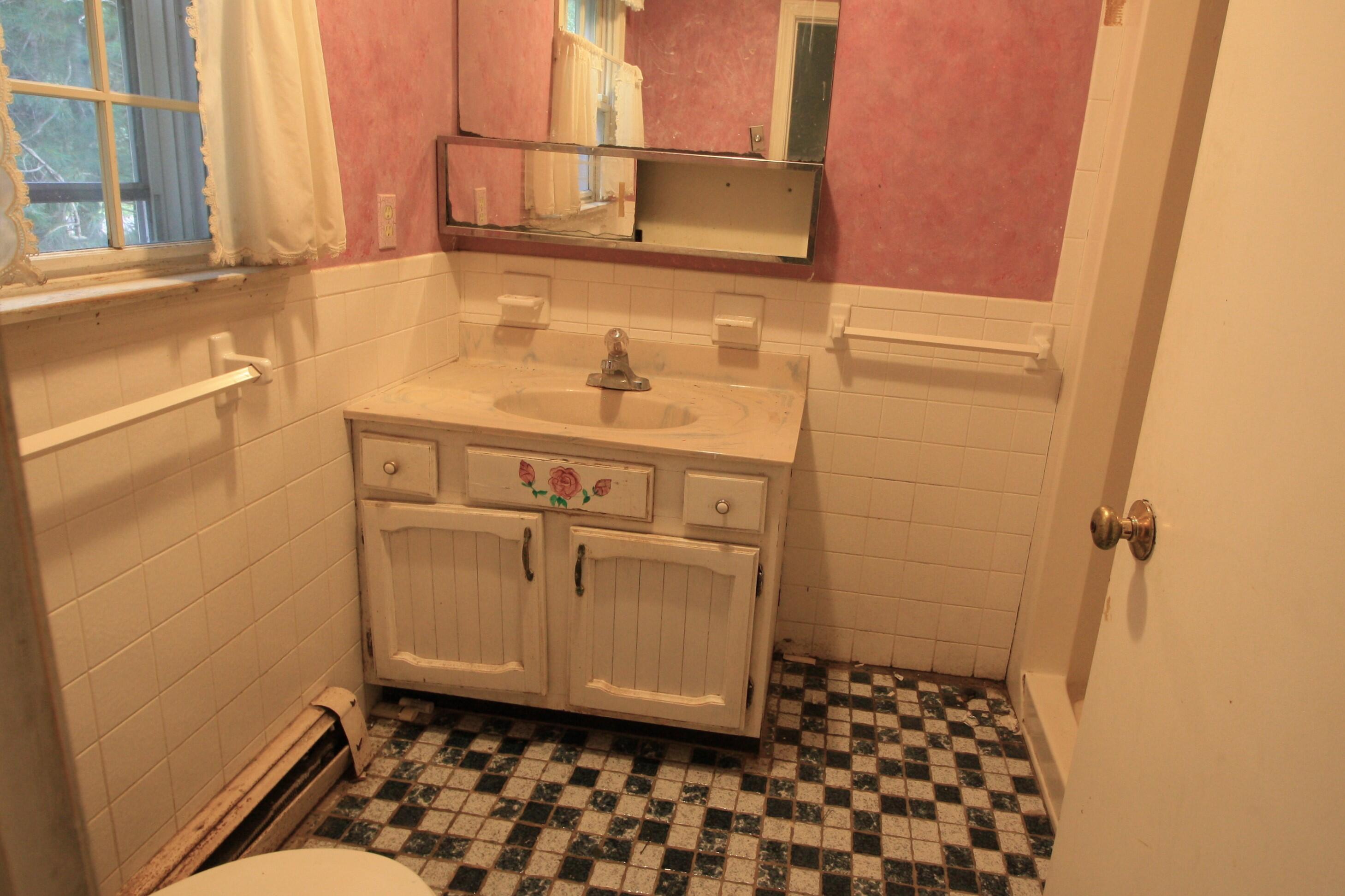 177 Thistle Drive Centerville, MA 02632 - Photo 18 of 22 a bathroom with a sink a toilet and a mirror