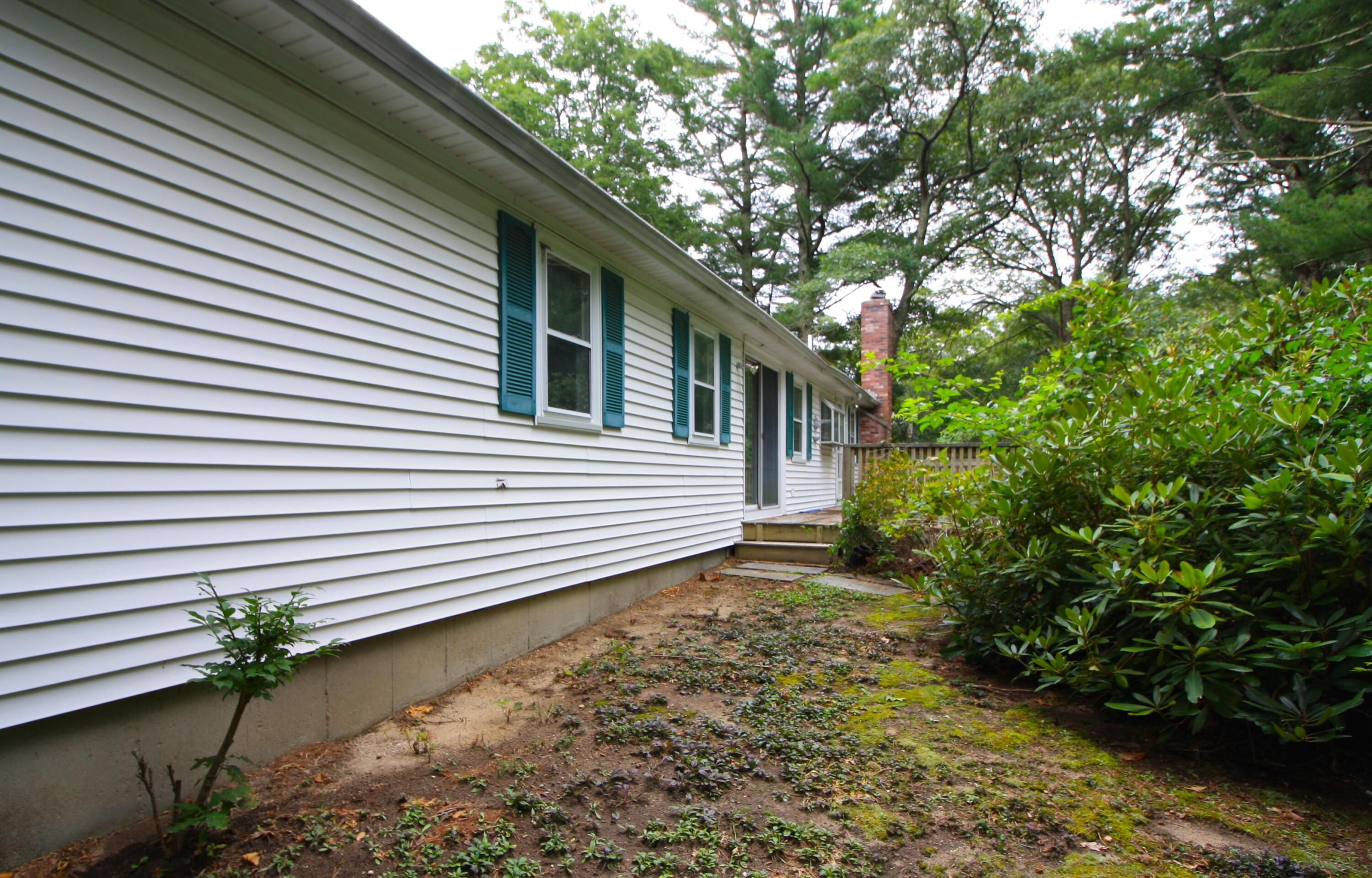 177 Thistle Drive Centerville, MA 02632 - Photo 3 of 22 a view of a house with a yard and garage
